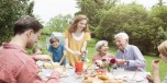 Happy extended family dining in garden