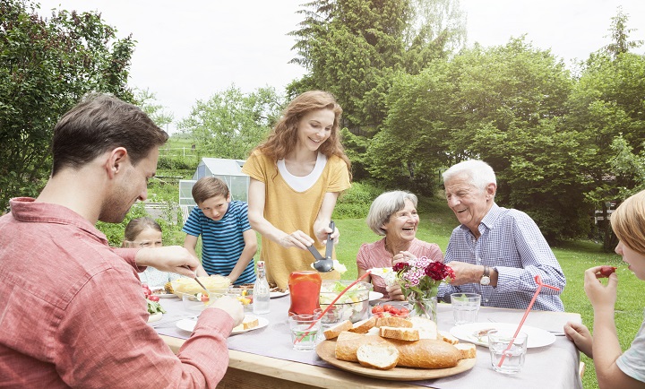 Happy extended family dining in garden