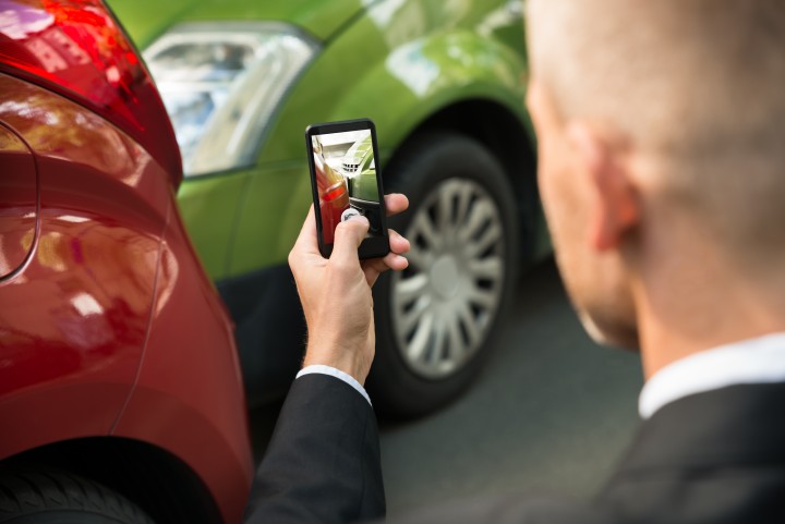 Male Driver Photographing Of Damaged Car