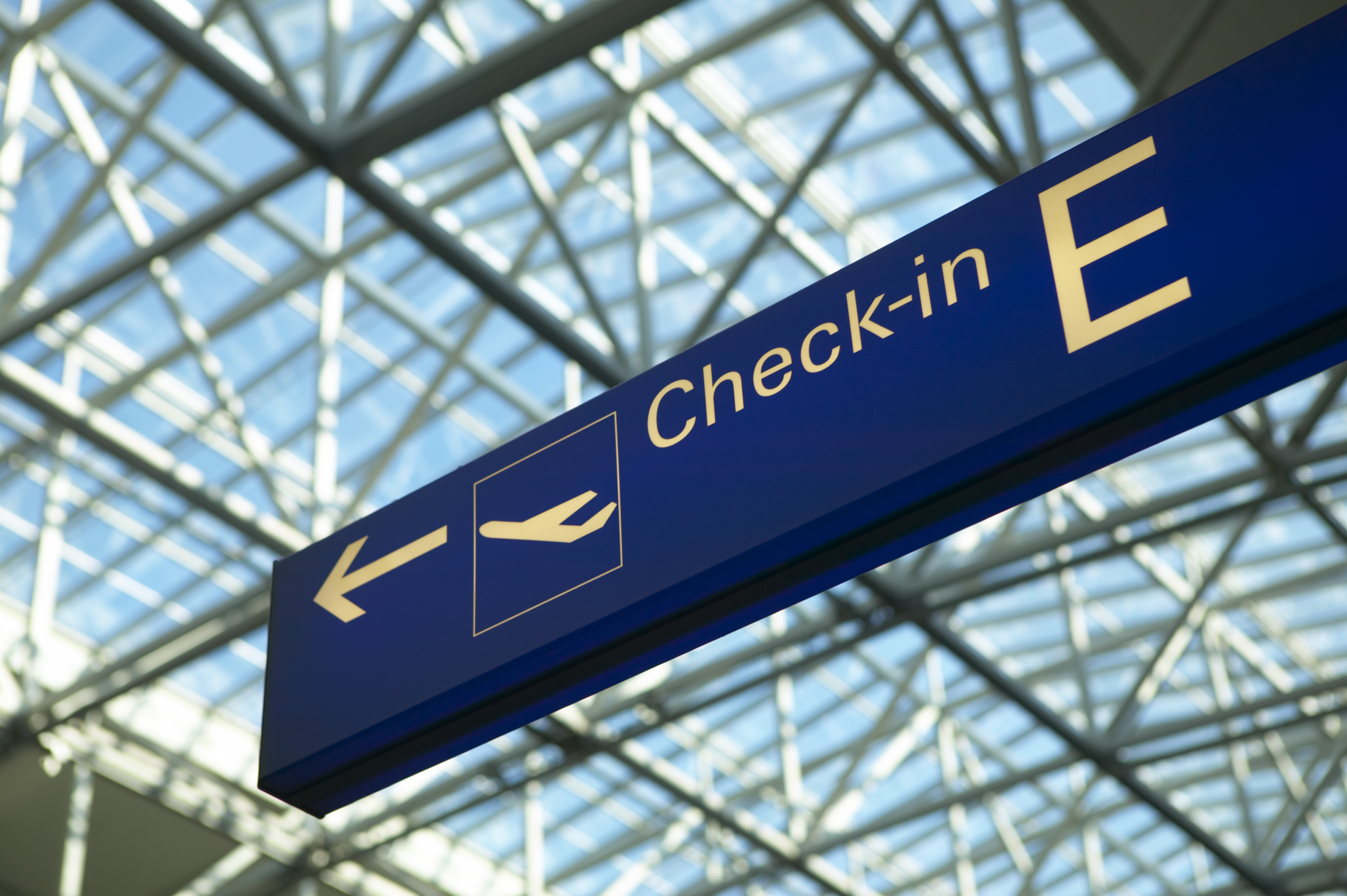 Check-in sign at airport, low angle view