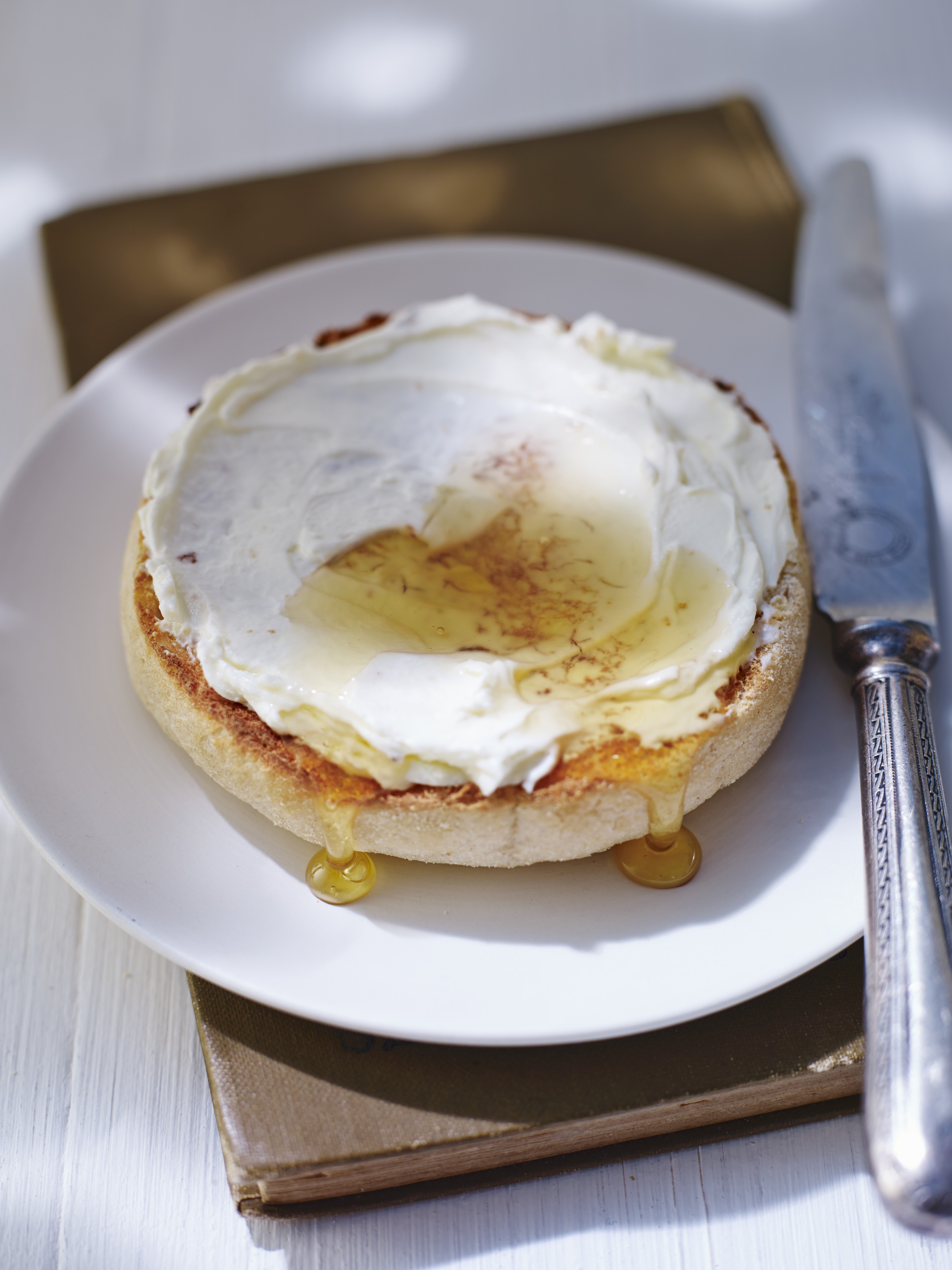 A bagel spread with cream cheese and honey