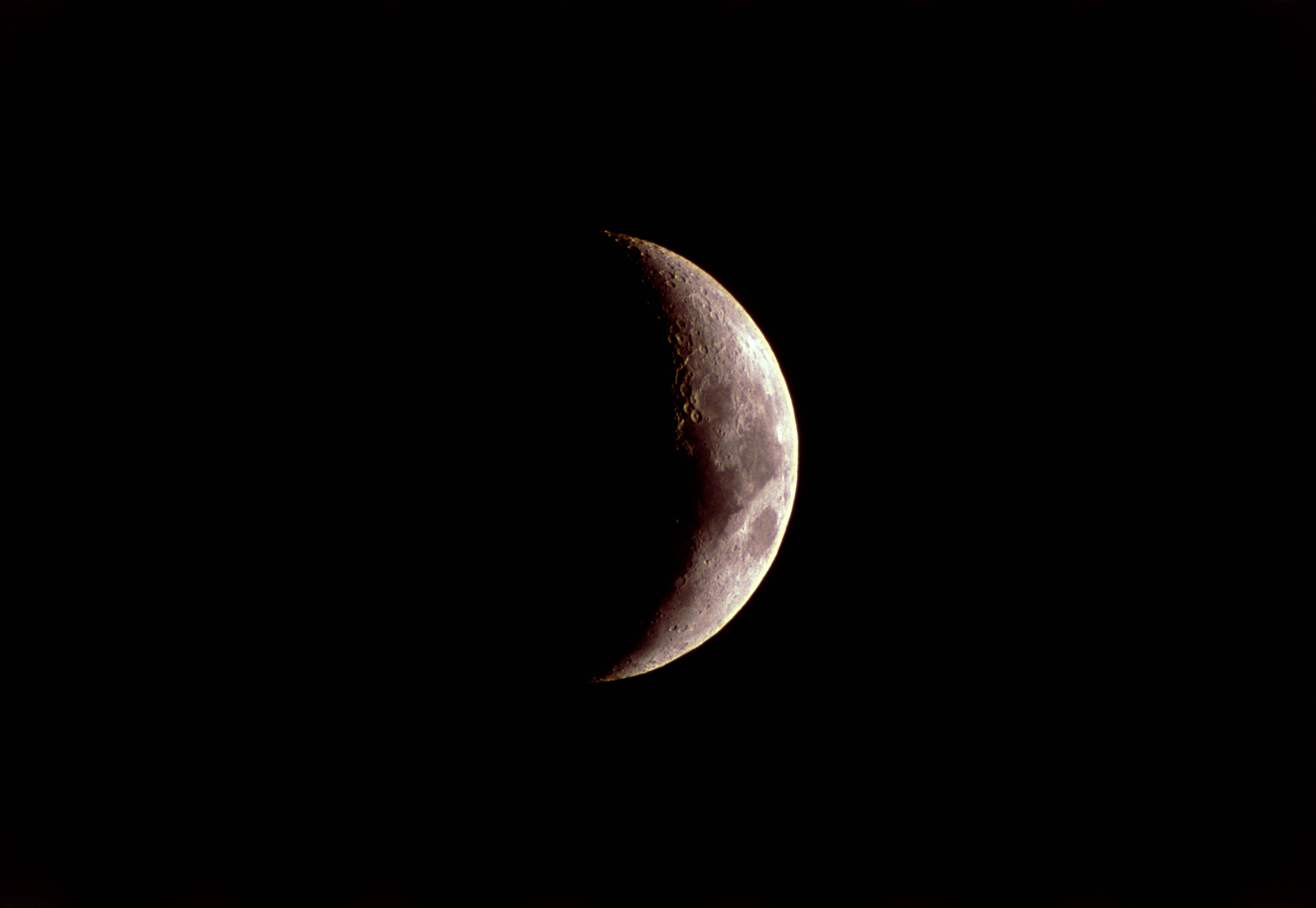 Waxing crescent Moon. Optical image of a waxing crescent Moon six days into its cycle. The Moon is said to wax when it is increasing in apparent size. The phases of the Moon are due to its orbit around Earth. When it lies in between the Earth and the Sun, only the unlit side faces us, and it is called a new Moon (day one). When it has moved round so that the Earth lies between it and the Sun, we see the full lit face, called a full Moon. A cycle takes around 28 days. North is at top. For the sequence of the Moon's phases, see images R340/526-532.