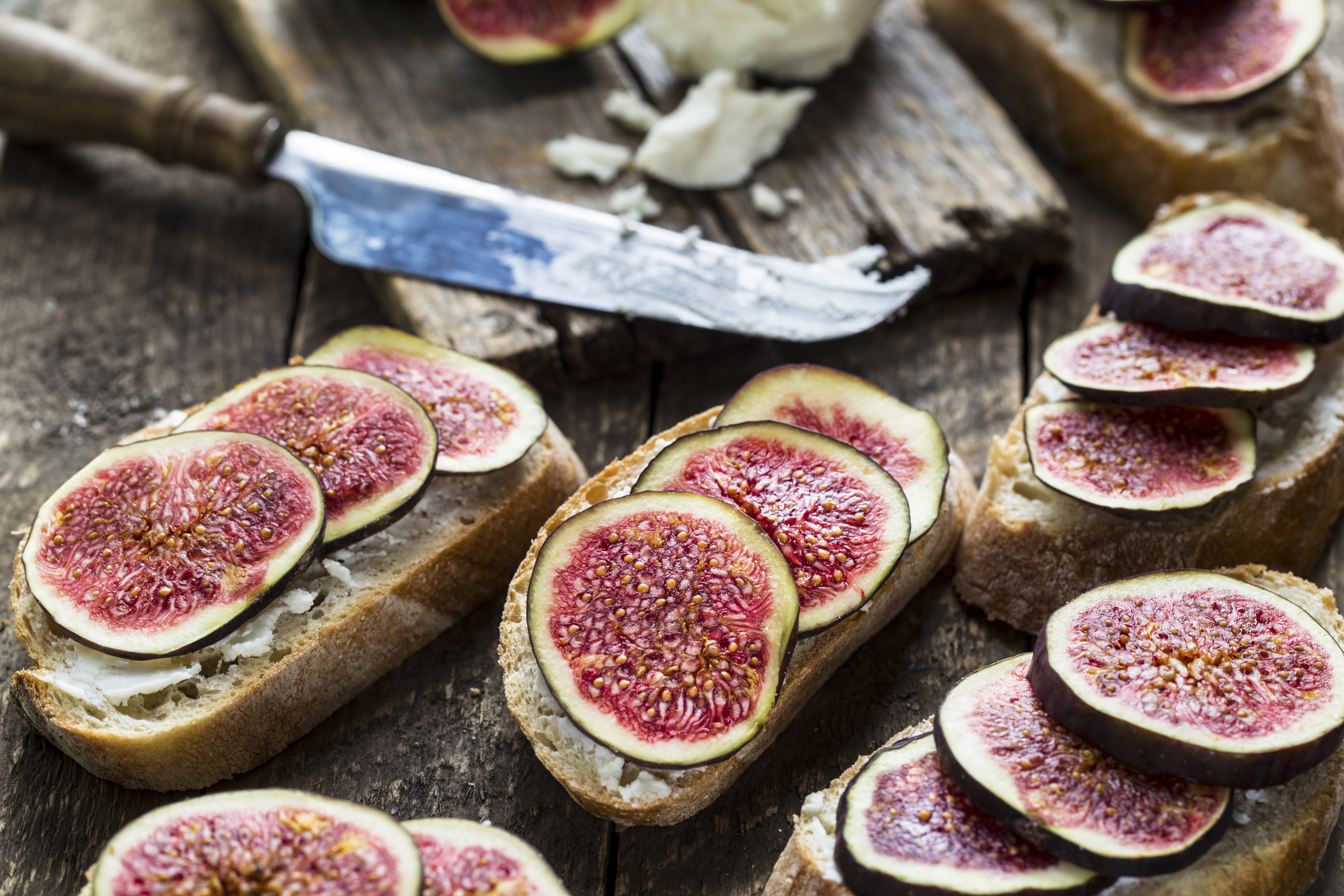 Sandwich with figs and goat cheese on wooden background