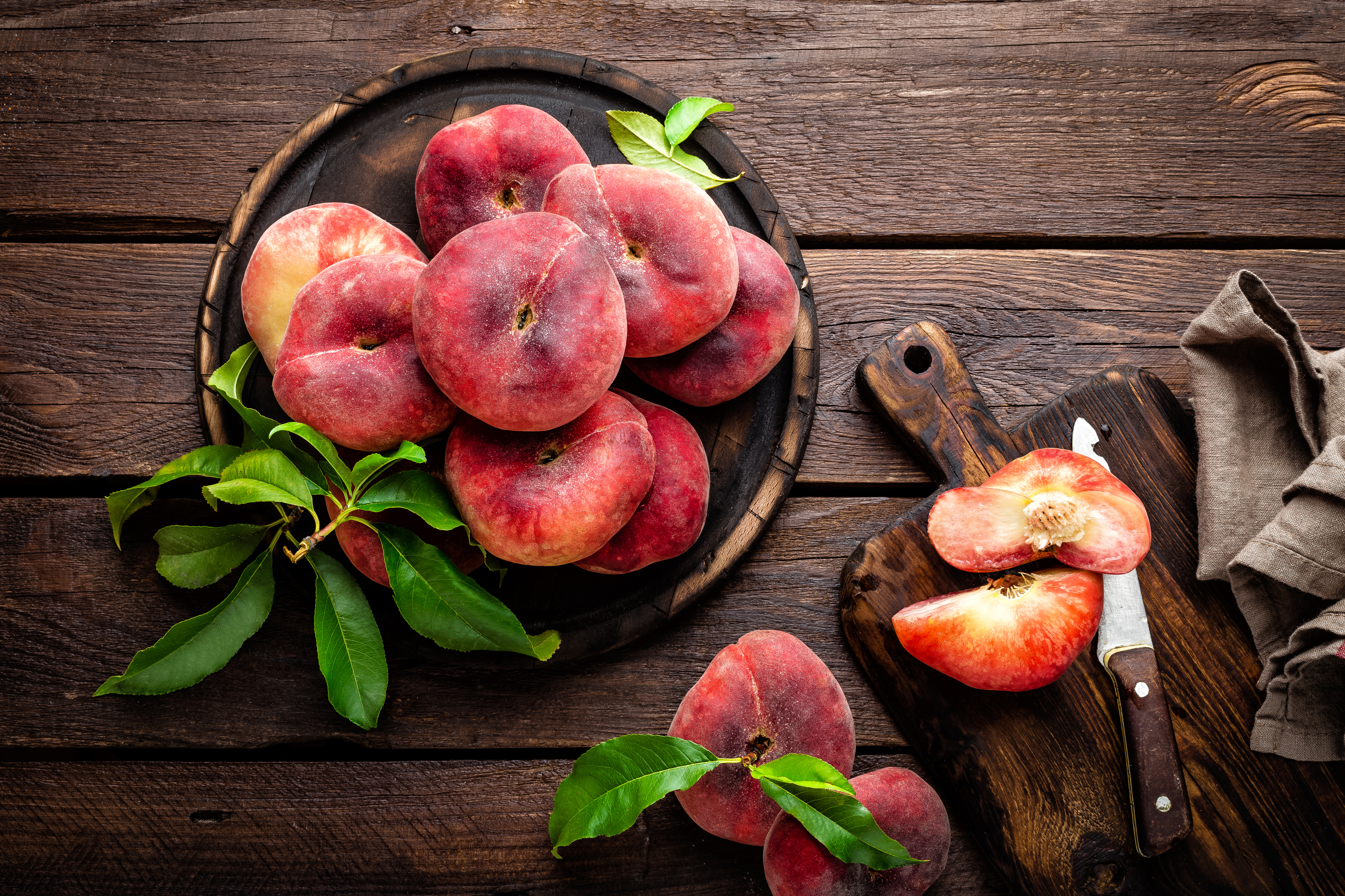 Peach, saturn or donut peaches with leaves