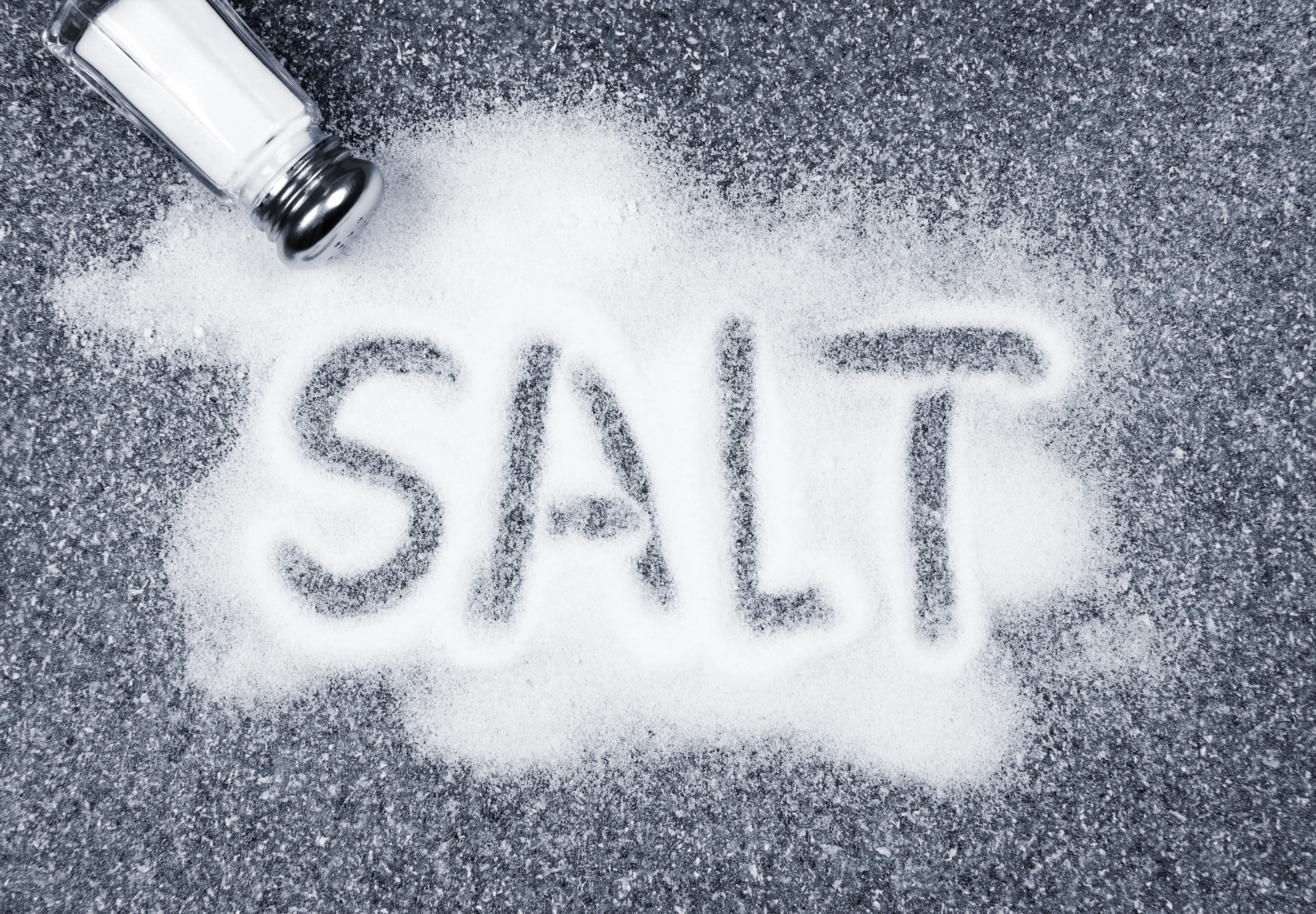 Salt written on counter in spilled salts from shaker