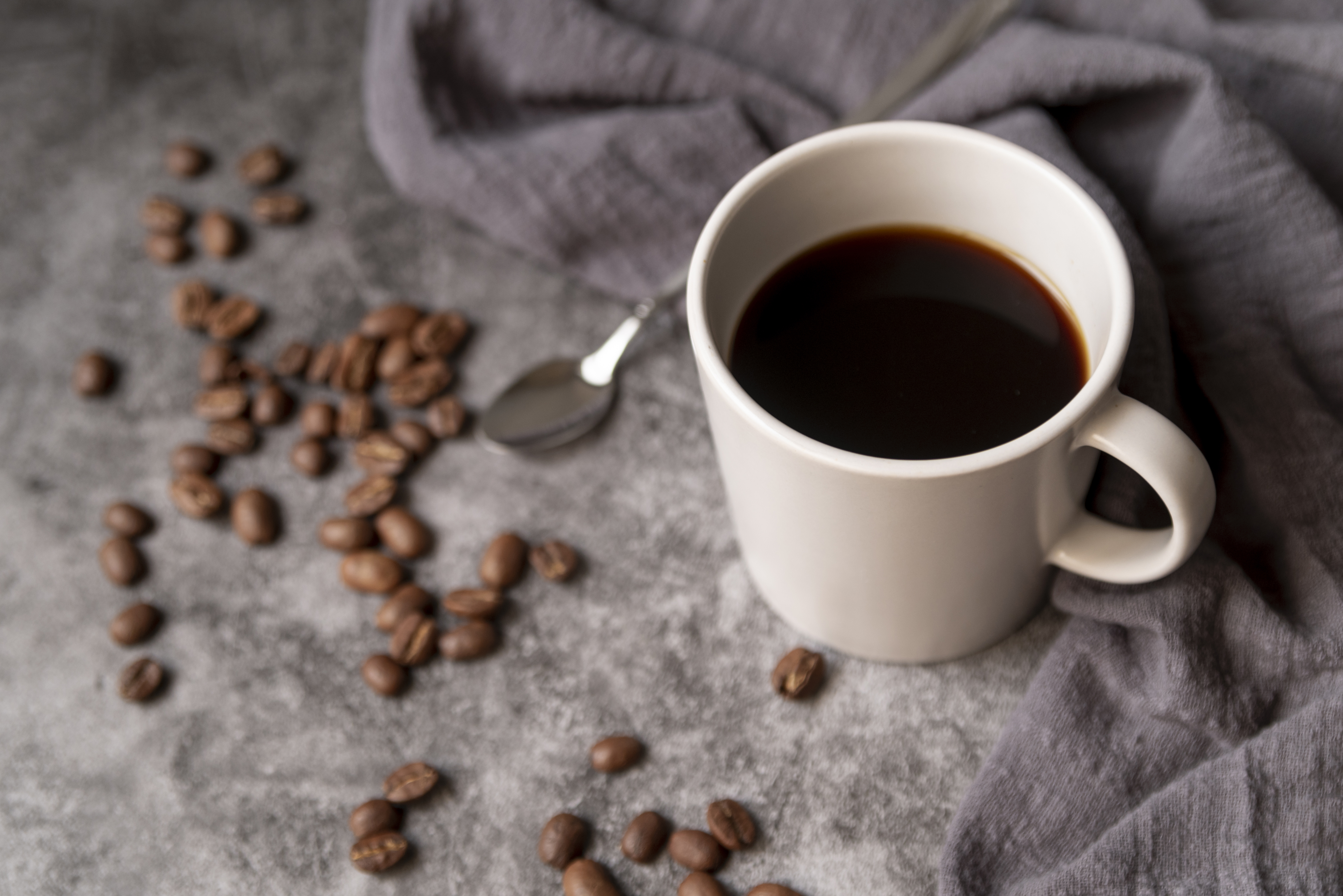 cup coffee with coffee beans spoon