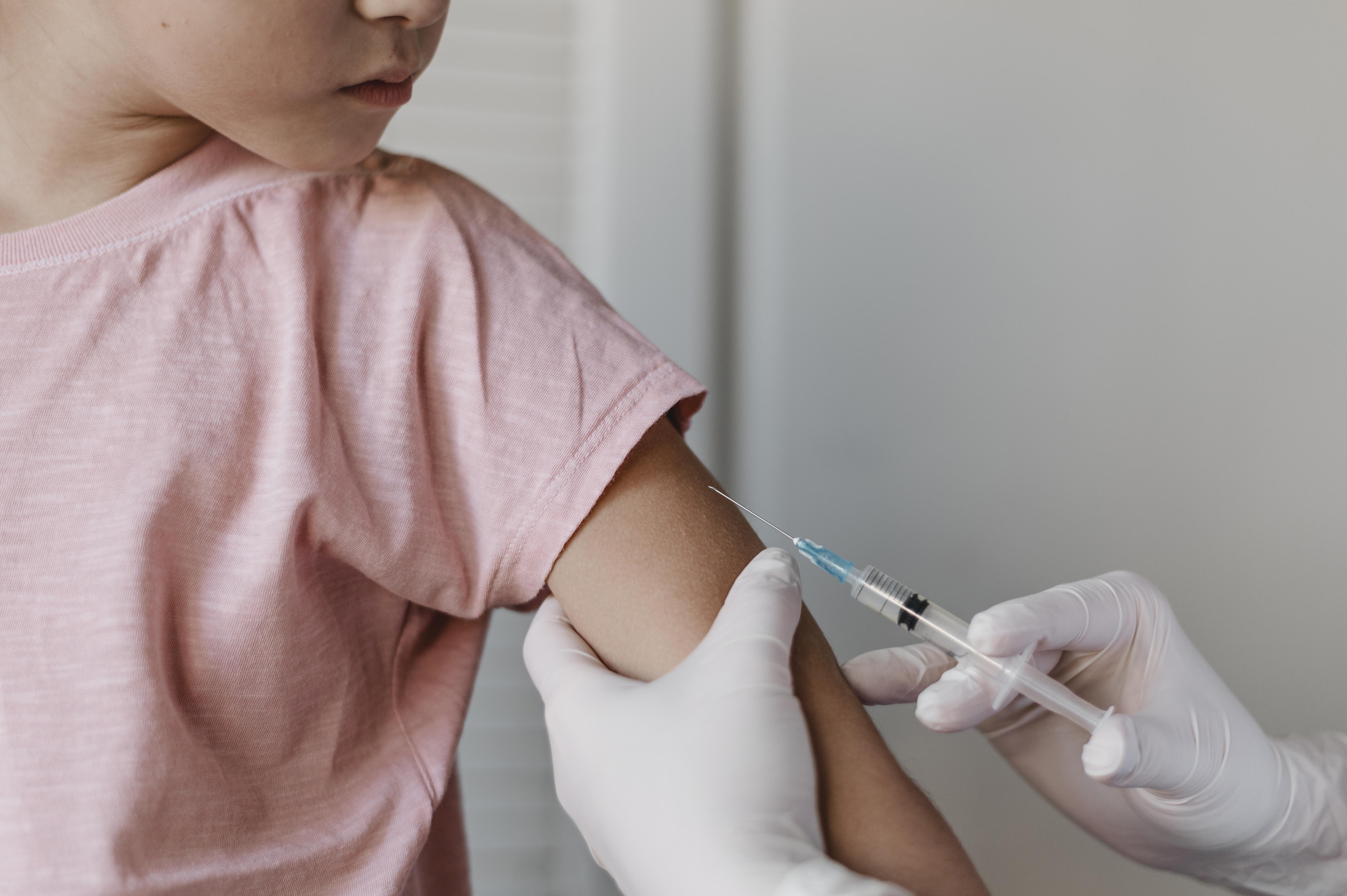 doctor administering vaccine kid