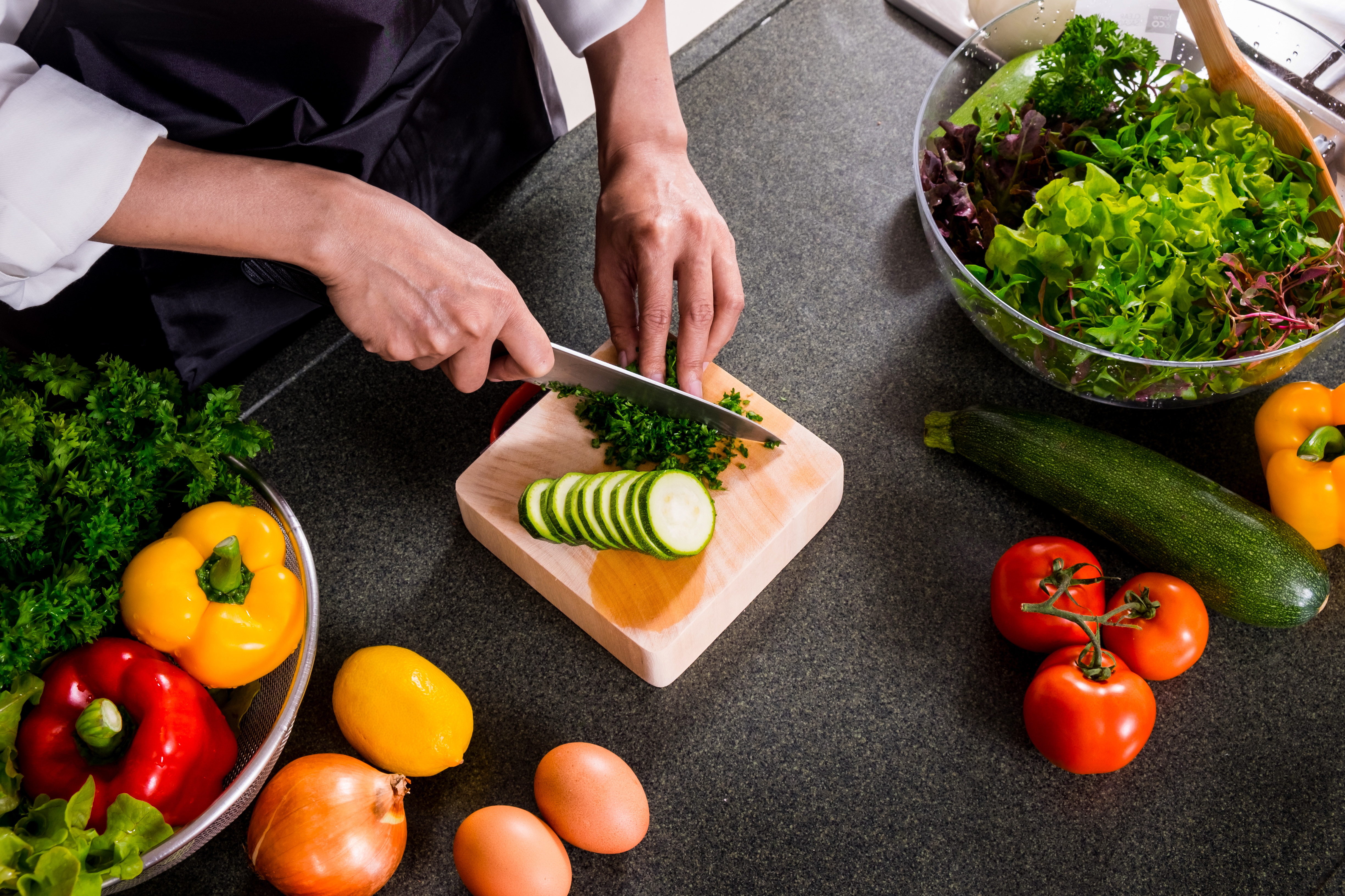 Healthy Woman makes fresh vegetable salad with olive oil, tomato and salad